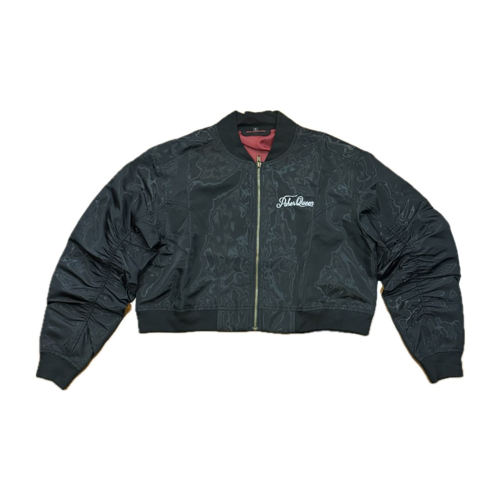 Black cropped bomber jacket with a zip front and ribbed hem, featuring a stylish logo on the chest.