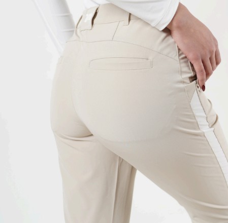 Rear view of a model wearing beige athletic pants with white stripes, showcasing the textile design.
