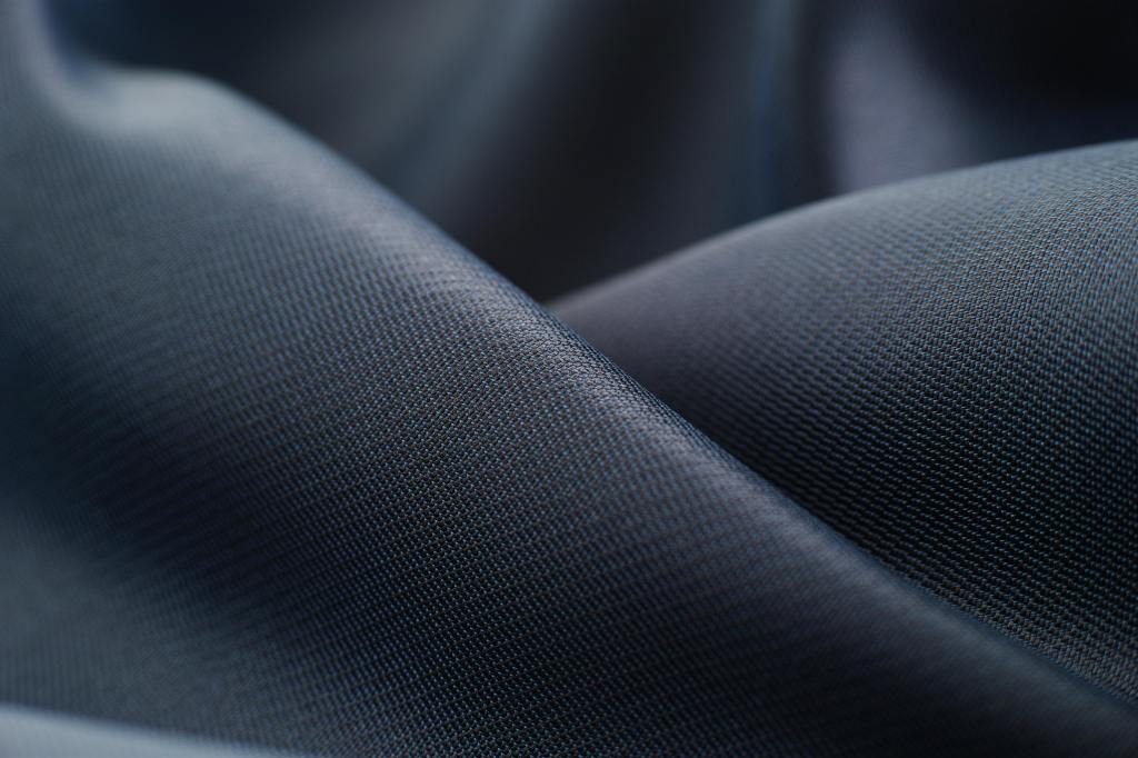 Close-up view of high-quality fabric, showcasing a smooth, textured surface suitable for performance apparel.